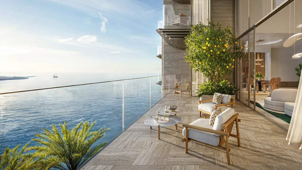 Solaya 4-bedroom duplex: travertine terrace with lounge chairs and a lemon tree, overlooking the sea through a glass balustrade